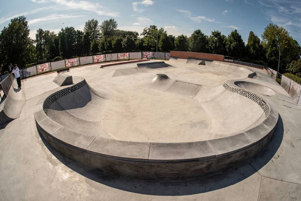 Vans Skatepark in Gorky Park, Moscow: wide view of the concrete bowl with tiled coping and the street area behind it
